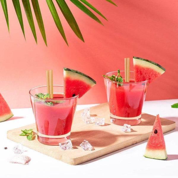 Refreshing watermelon cocktails served in glasses with eco-friendly straws, garnished with mint leaves.