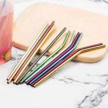 Charger l'image dans la galerie, Colorful stainless steel straws on a wooden surface, featuring straight and curved designs, reusable and eco-friendly.